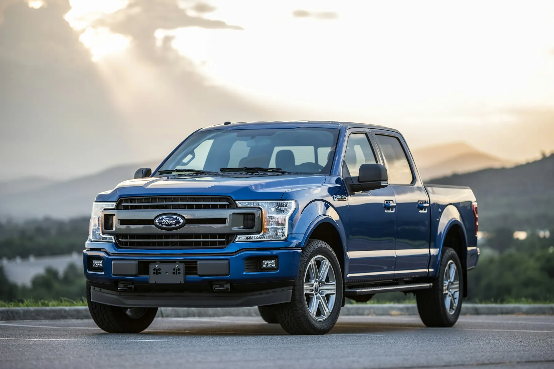 Blue Ford F-150 on a mountain road